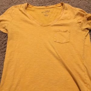 a yellow tee shirt